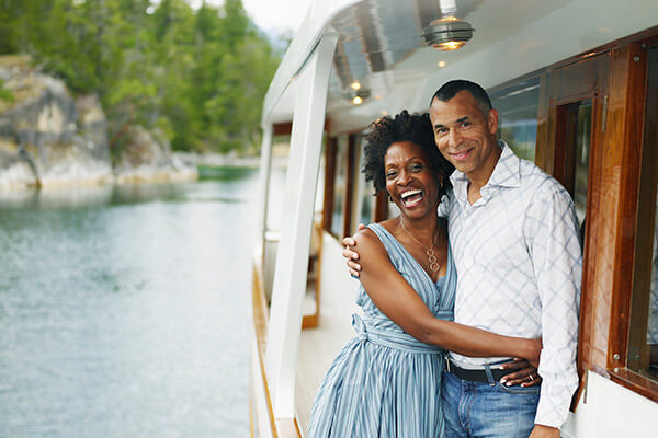 rich couple laughing on a yacht